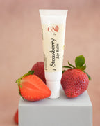 Smooth strawberry lip balm texture inside open tin showing nourishing formula